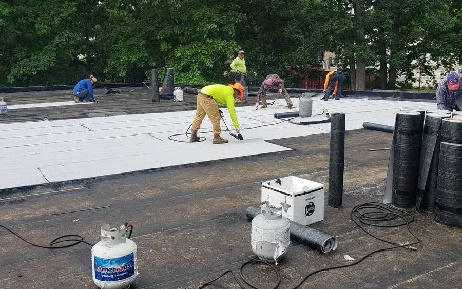 Roofers installing a new flat roof