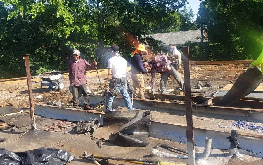 Roofing crew working on a low-slope roof deck