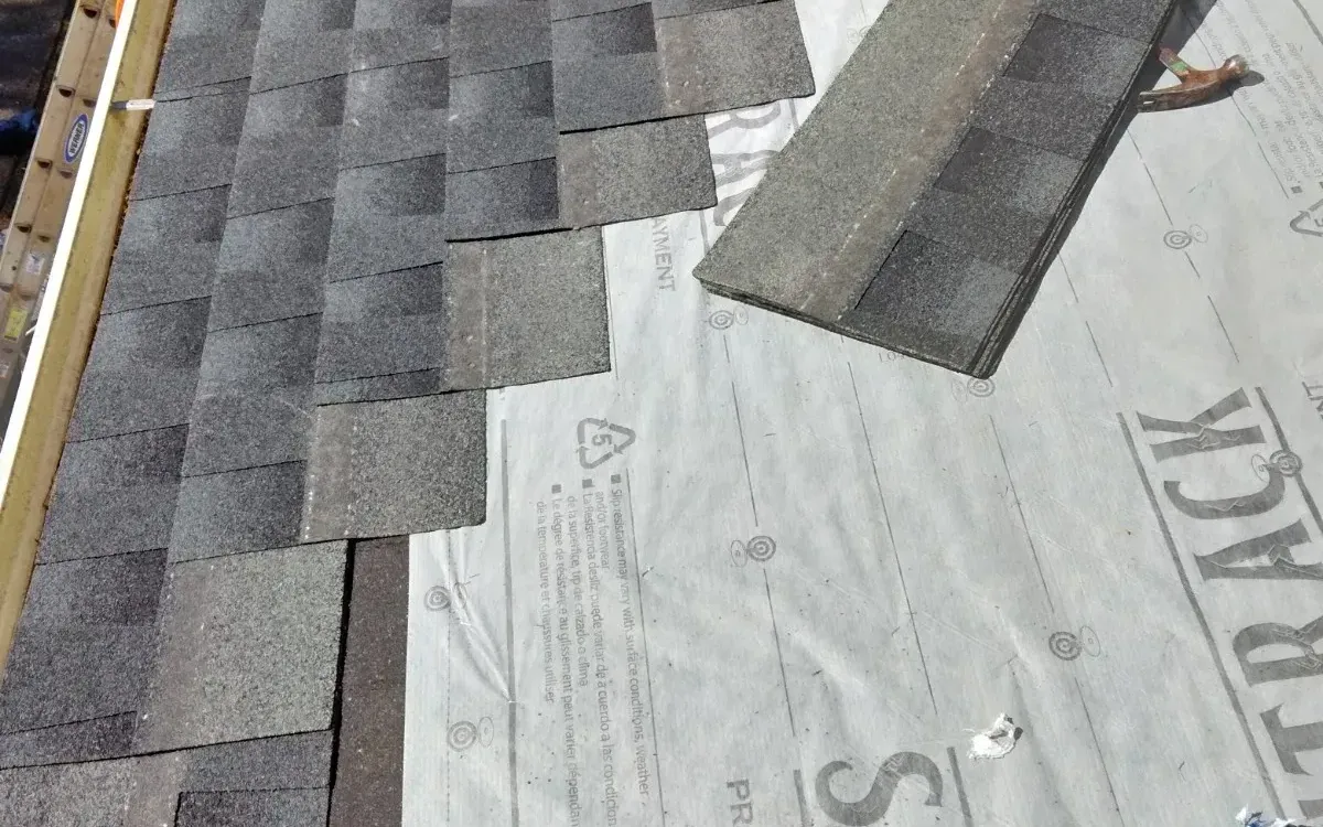 Shingles being nailed down on a new roof